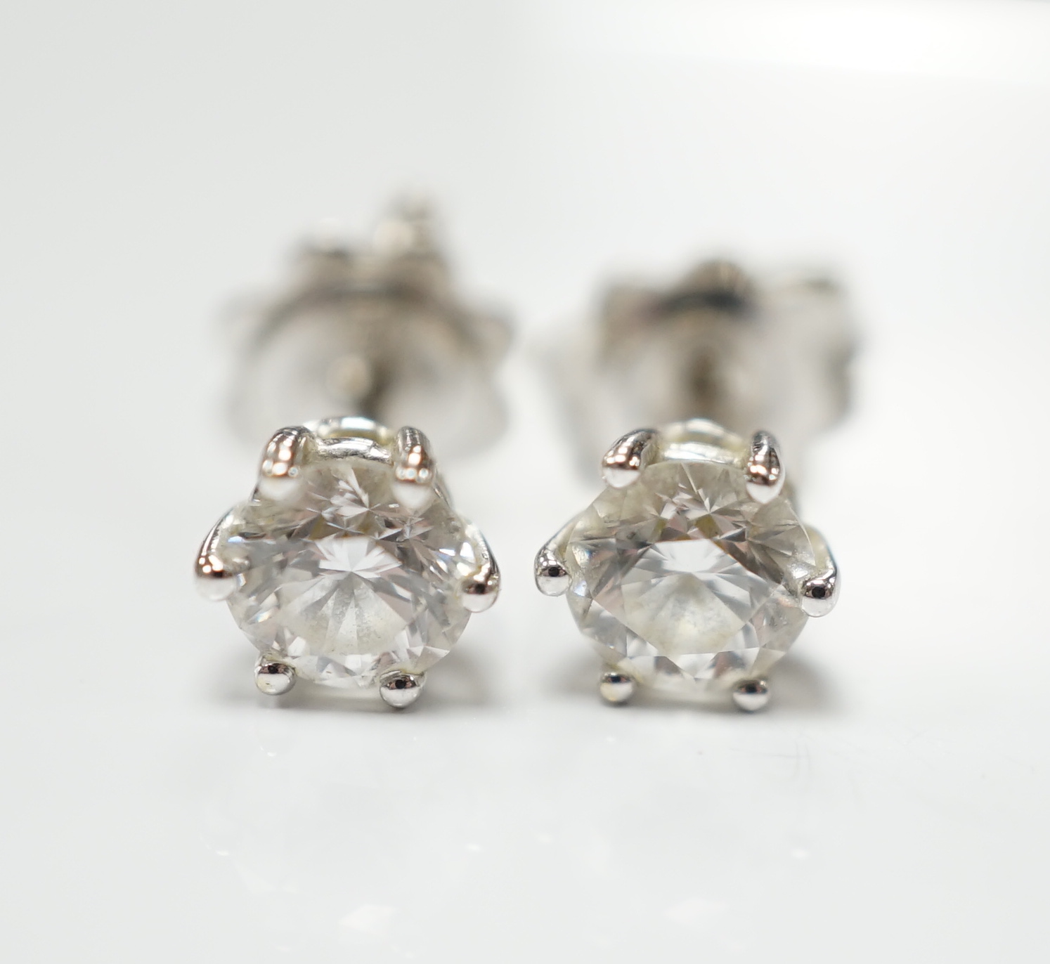 A pair of 18ct white gold and solitaire diamond set ear studs